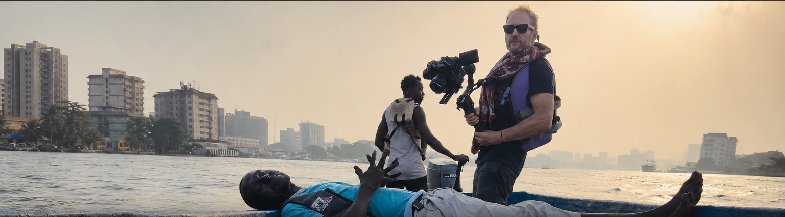 Director Geoff Browne filming on a boat in Lagos, Nigeria during the making of Godpower