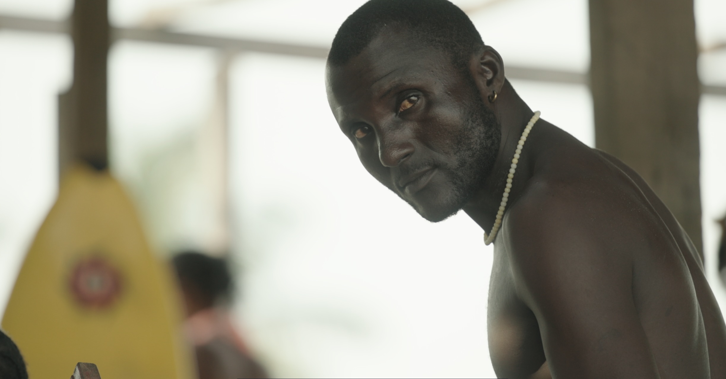 Close portrait of Godpower, a surf instructor at Tarkwa Bay